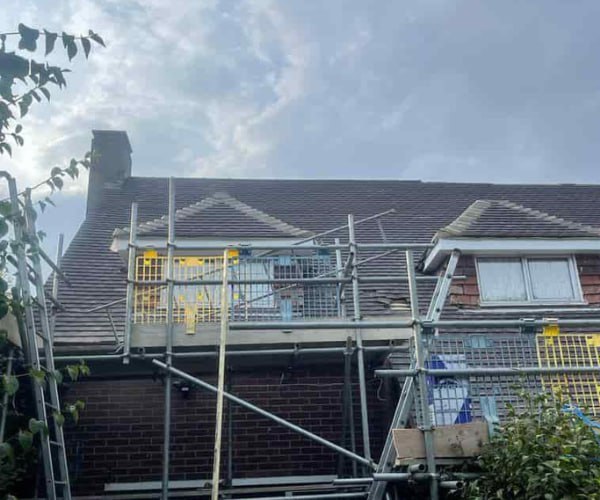 This is a photo of a roof with two dormers that is having some damaged tiles replaced. Works carried out by LKP Roofing Thorne